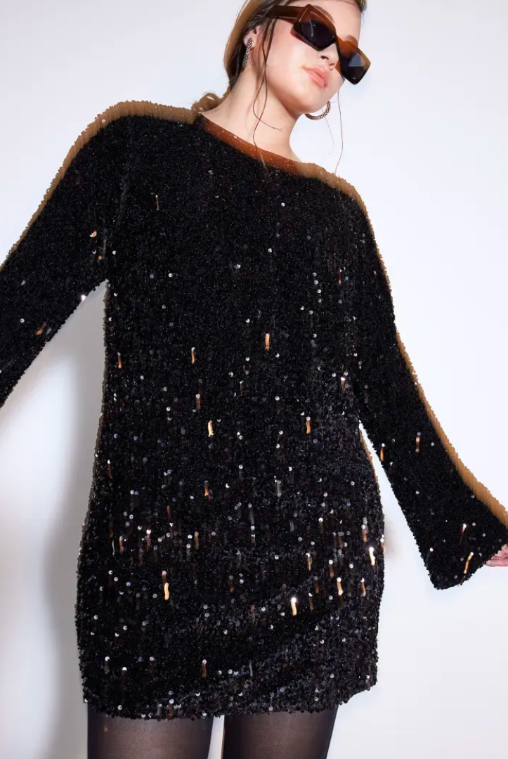 White Lise sequin mini dress by Lumina Wear with long sleeves, fitted style, and sparkling embellishments, showcased on a model.