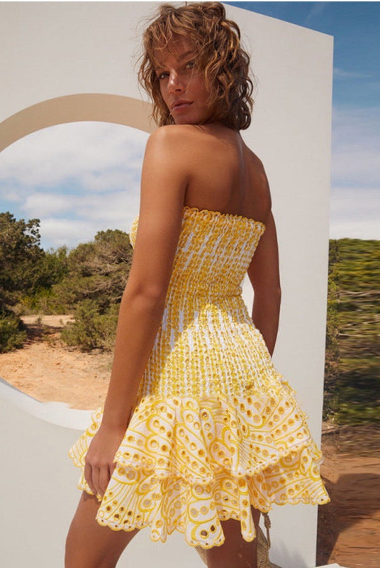 Yellow Seraphina strapless mini dress by Lumina Vancouver, shown on a model, highlighting its fitted silhouette and stylish design.