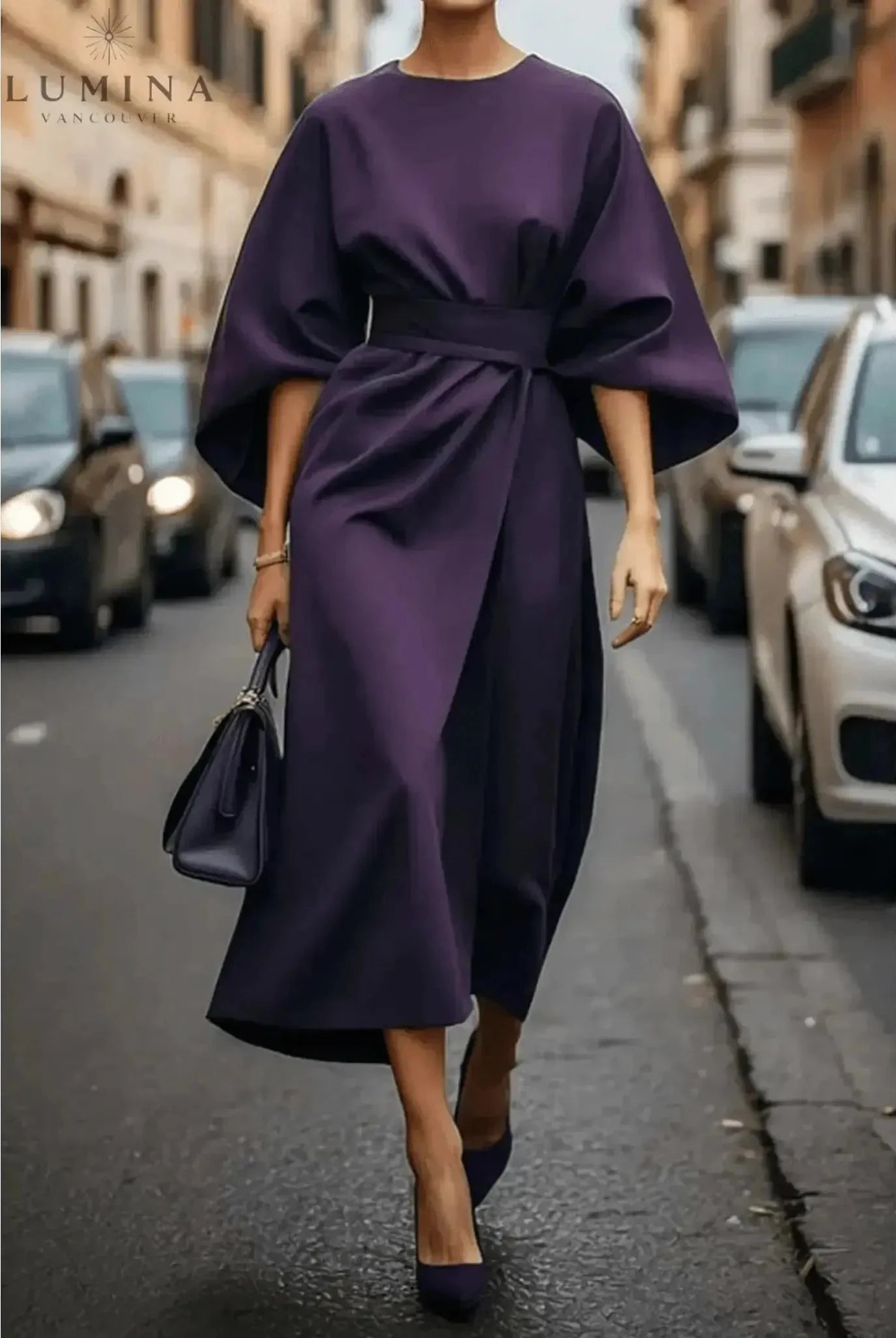 Navy blue Sonia elegant dress by Lumina Wear featuring a stylish belt and flowing fabric, displayed on a hanger.