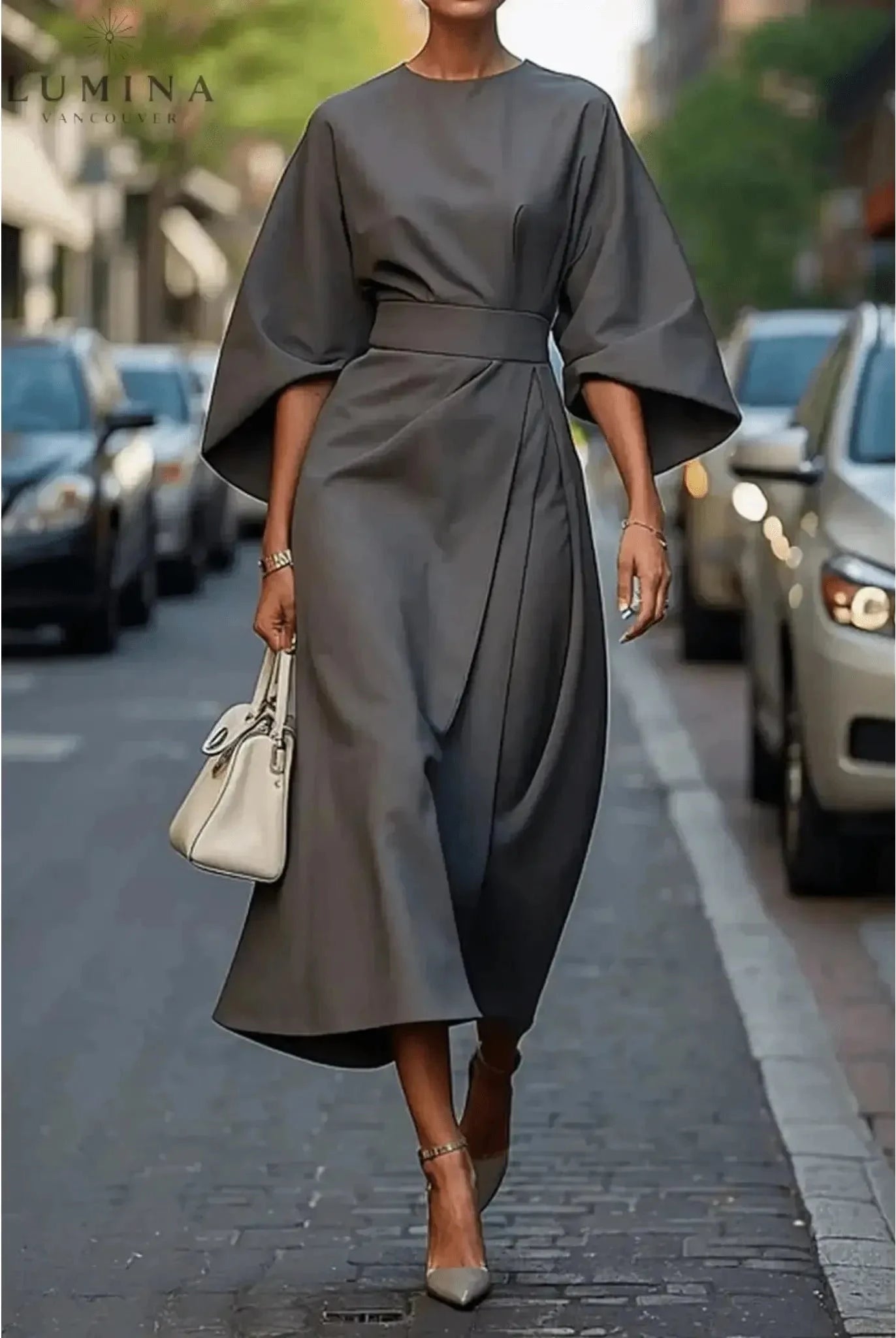 Navy blue Sonia elegant dress with belt by Lumina Wear, shown on a model with a fitted silhouette and stylish design.