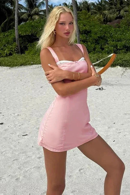 Pink satin mini dress with lace trim from Lumina Wear, featuring a fitted silhouette and delicate lace accents.
