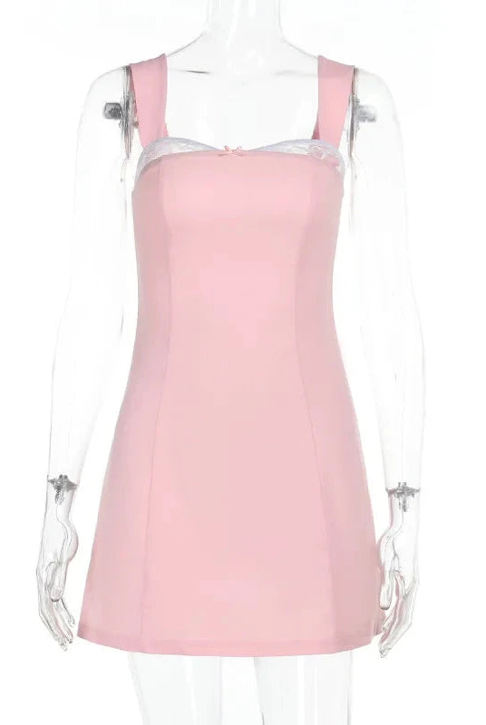 Pink satin mini dress with lace trim by Lumina Wear, featuring a fitted silhouette and delicate lace details.