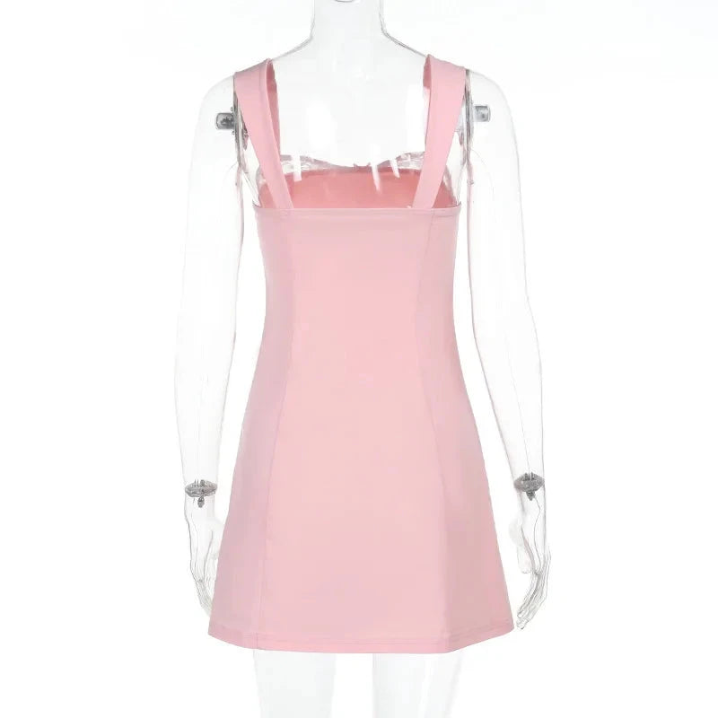 Pink satin mini dress with lace trim by Lumina Vancouver, showcased on a hanger with detailed lace accents and smooth fabric.