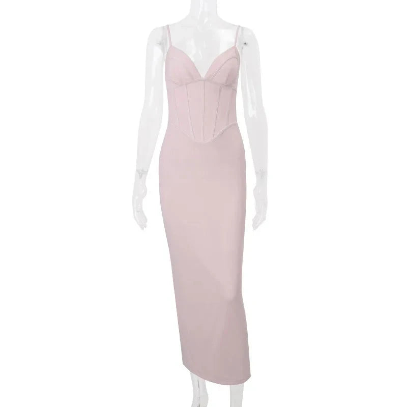 Pink Rosamond bodycon dress with corset bodice by Lumina Vancouver, shown on a model, highlighting its fitted silhouette and detailed design.