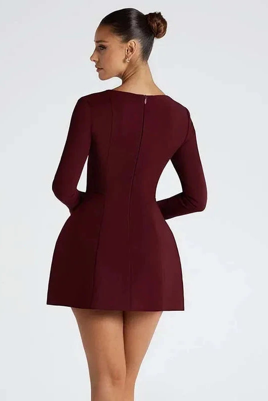 Red women's mini dress by Lumina Wear featuring a fit and flare silhouette, styled with a V-neck and sleeveless design.