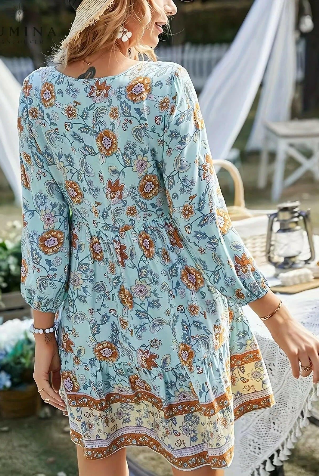 Sky-blue Katariina boho dress by Lumina Wear featuring flowing fabric and intricate embroidery, displayed on a dress form.