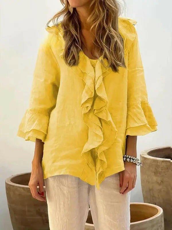 Blue women's casual cotton ruffle shirt with 3/4 sleeves from Lumina Vancouver, displayed on a hanger.