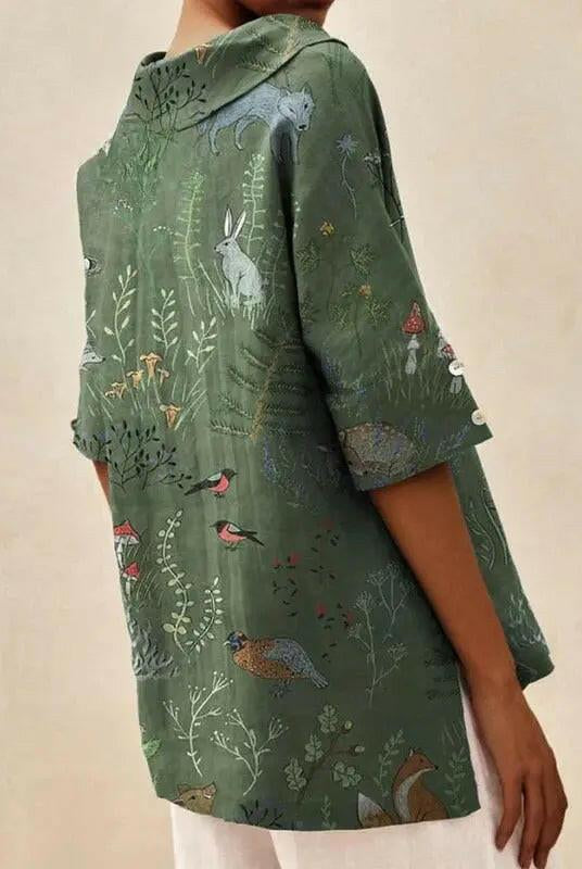 Women's casual V-neck blouse by Lumina Wear featuring woodland and animal pattern print in green.