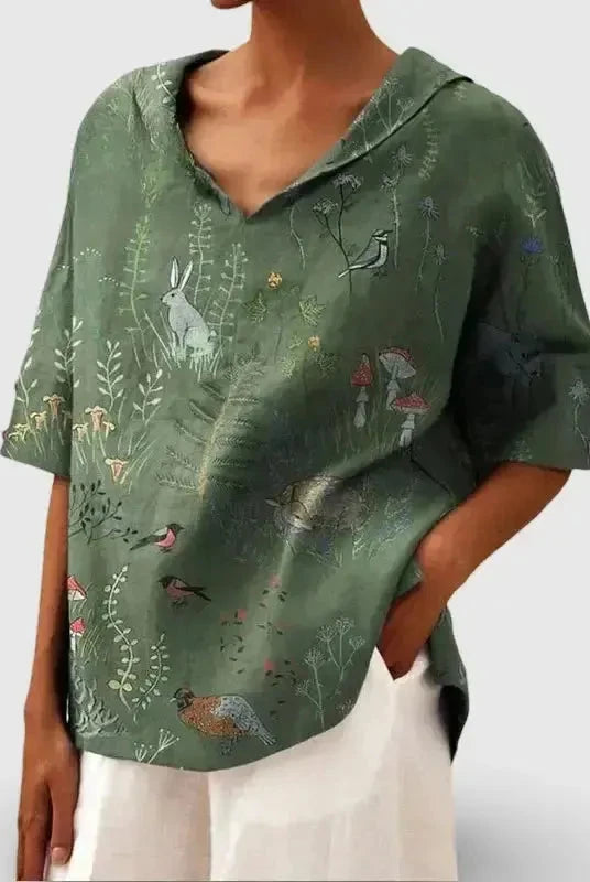 Women's casual V-neck blouse by Lumina Wear featuring a green woodland and animal pattern print.