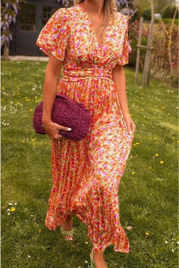 Orange Isabella maxi dress by Lumina Vancouver, elegant wedding guest dress with flowing fabric and stylish design.