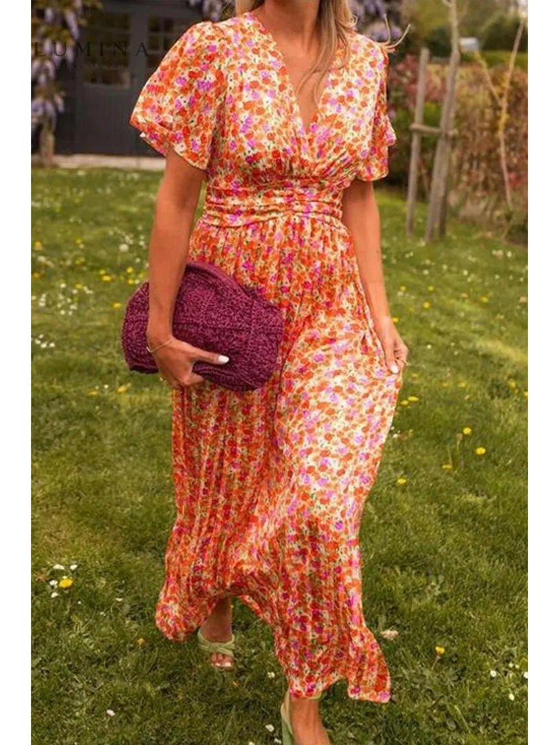 Orange Isabella maxi dress by Lumina Vancouver, elegant wedding guest dress with flowing fabric and stylish design.