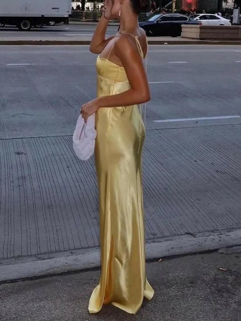 Lumina Vancouver Ursule suspender maxi dress, elegant wedding guest dress in flowing fabric with adjustable straps and a stylish silhouette.