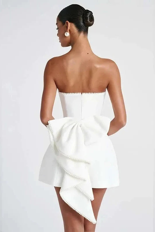 Lumina Wear Anneli mini dress in white satin, strapless design, showcasing a sleek, elegant fit with smooth fabric detail.