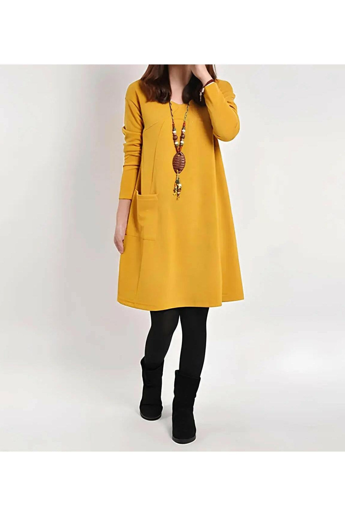 Yellow Torunn dress by Lumina Wear featuring a stylish design, displayed on a model in a bright, modern setting.