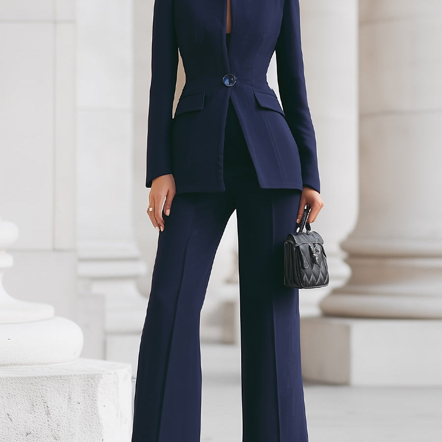 Navy blue Cassia set by Lumina Wear featuring a blazer and wide-leg trousers, displayed on a hanger against a white background.
