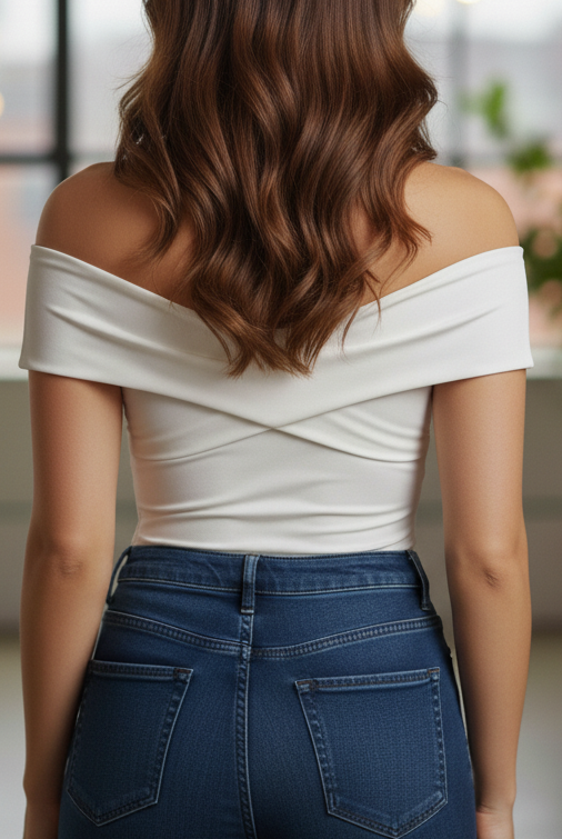 White Luna sleeveless V-neck pleated blouse by Lumina Vancouver, shown on a model with a fitted waist and elegant design.