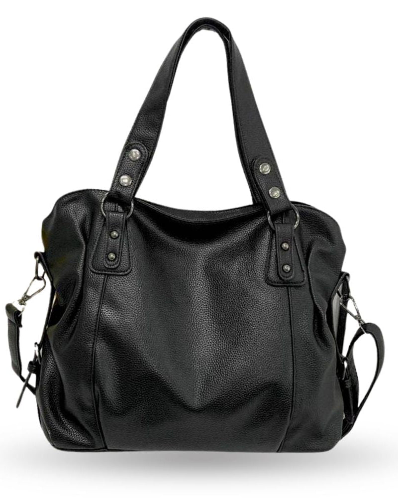 Lumina Wear Lunelle black handbag with spacious interior and versatile strap, shown with chocolate-colored accessories.