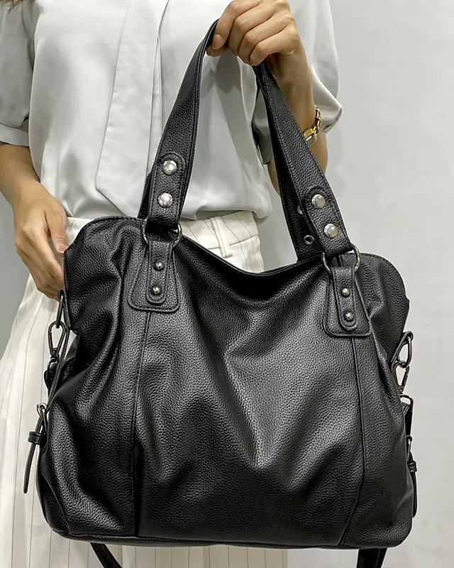 Lumina Wear Lunelle black handbag with spacious interior and versatile strap, shown with chocolate-colored accents.