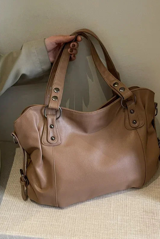 Black Lunelle handbag by Lumina Wear with a spacious interior and versatile strap, stylish for everyday use.
