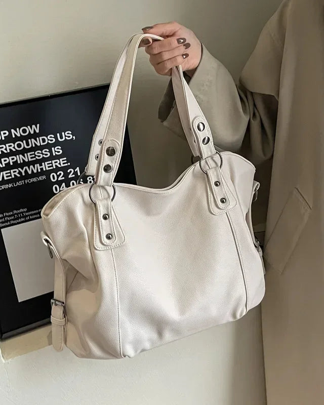 Lumina Wear Lunelle black handbag with spacious interior and versatile strap, featuring sleek design and elegant style.