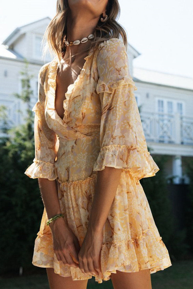 Suzette Lumina V-Neck Mini Dress with floral print, white fabric, showcasing a stylish V-neck and lightweight design.