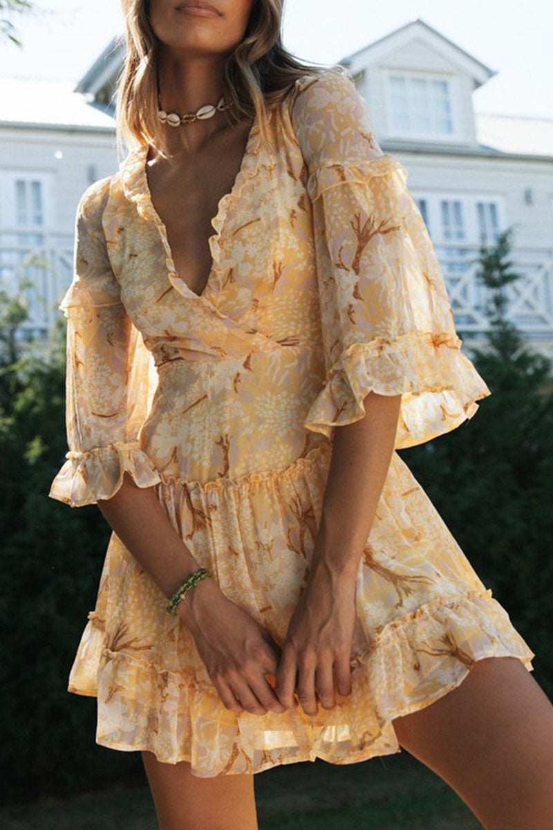 Suzette V-neck mini dress with white floral print by Lumina Vancouver, shown on a model with a fitted waist and short sleeves.