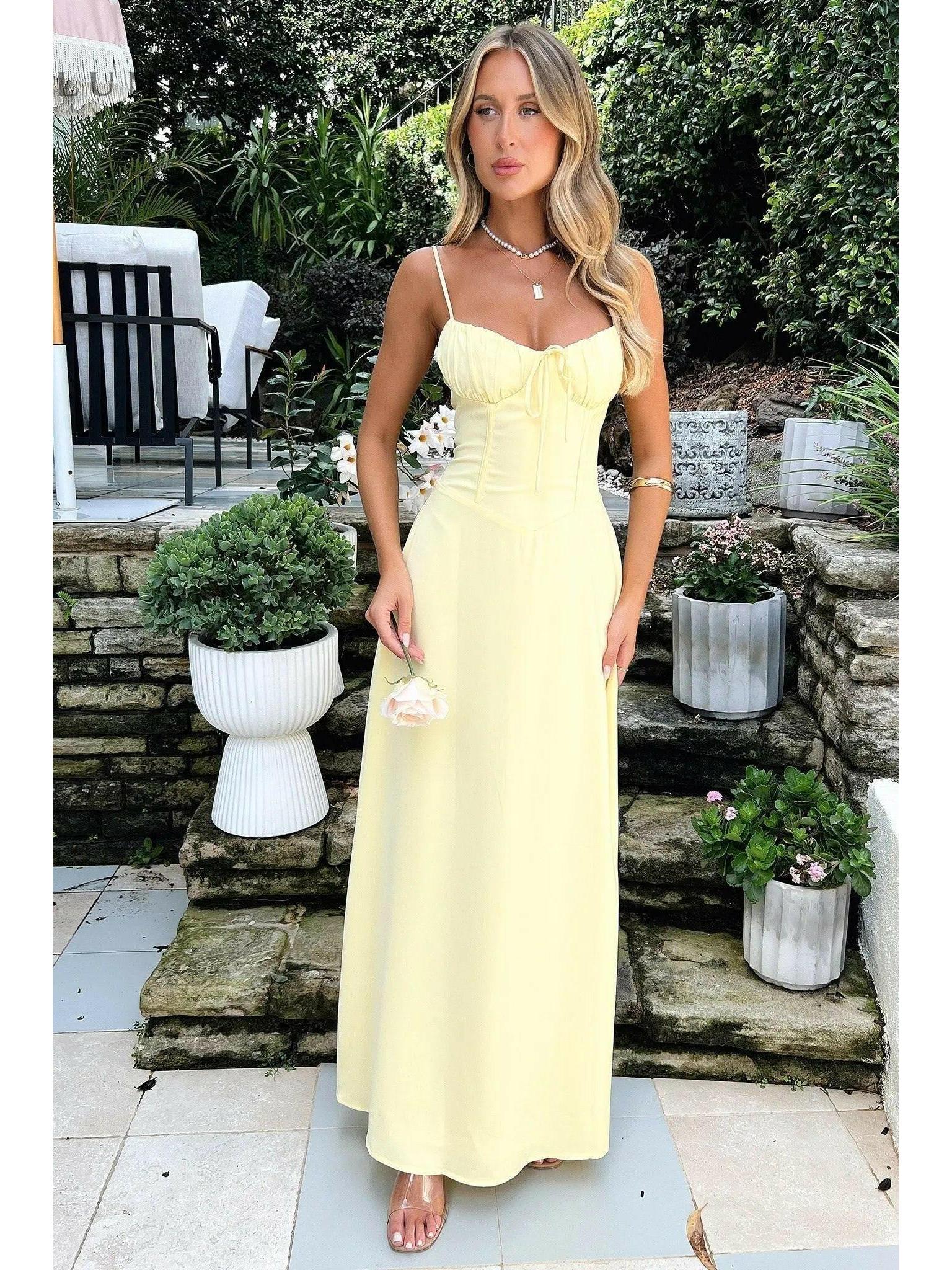Yellow Maelys lace-up sleeveless maxi dress by Lumina Vancouver, perfect for wedding guest attire, shown on size 8-10 model.