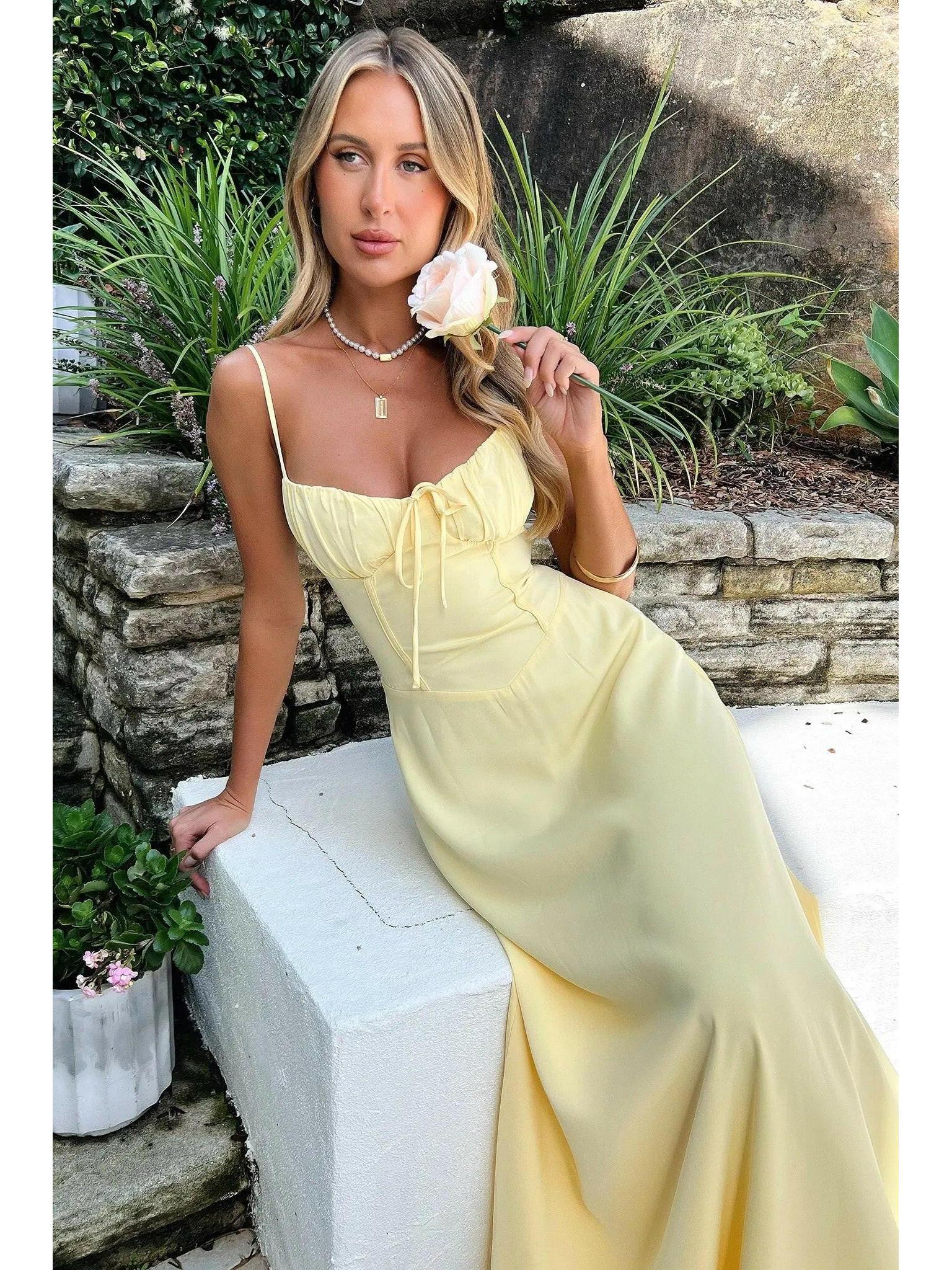 Yellow Maelys lace-up sleeveless maxi dress by Lumina Vancouver, perfect for wedding guests, shown on a model.