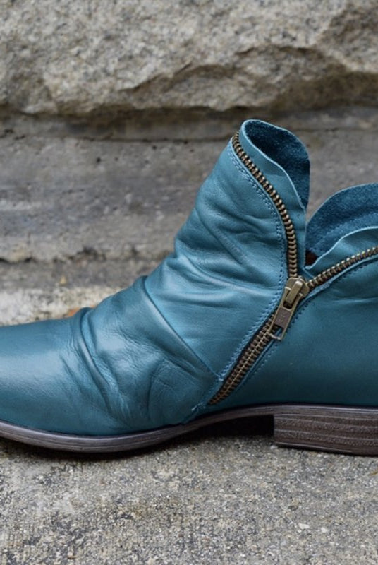 Makayla Lumina black leather ankle boots with sleek design, pointed toe, and low heel, showcasing their stylish silhouette.