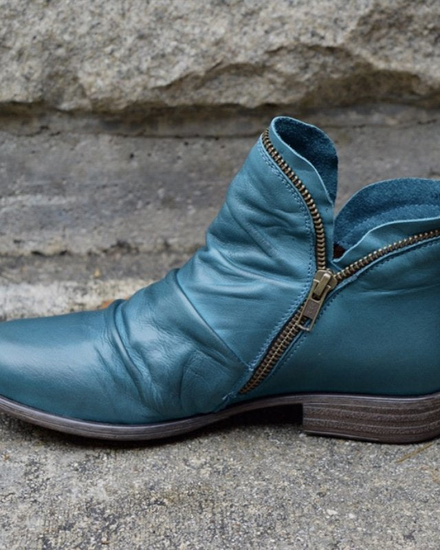 Makayla Lumina black leather ankle boots with sleek design, pointed toe, and low heel, showcasing their stylish silhouette.