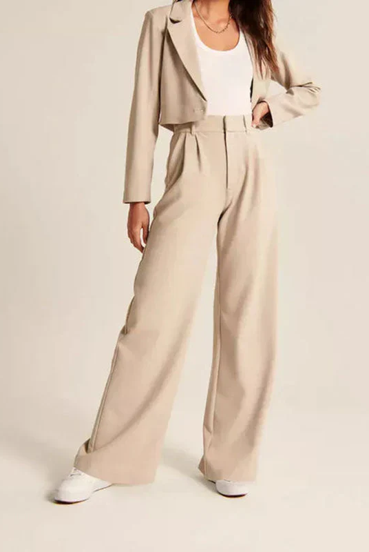 Cream high-waisted wide-leg women's trousers by Lumina Wear, styled with a relaxed fit and modern silhouette.