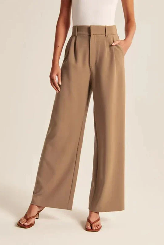 Cream high-waisted wide-leg trousers for women by Lumina Wear, styled with a relaxed fit and elegant silhouette.