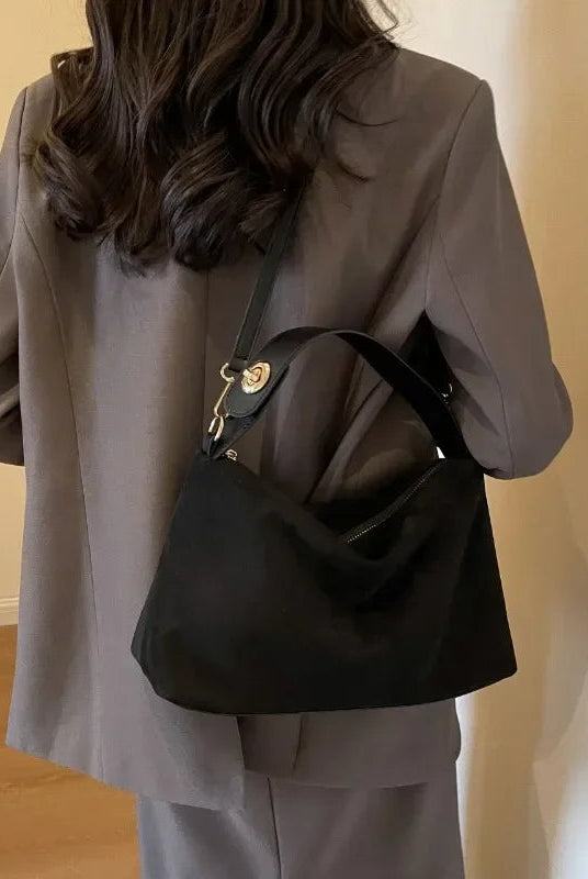 Textured Marielle Lumina minimalist shoulder bag with curved shape, coffee color, stylish handbag for everyday use.
