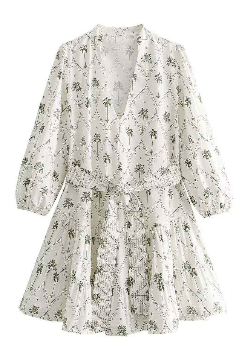 White and green Marin Willow wrap dress with V-neck by Lumina Vancouver, displayed on a model in a mini dress style.