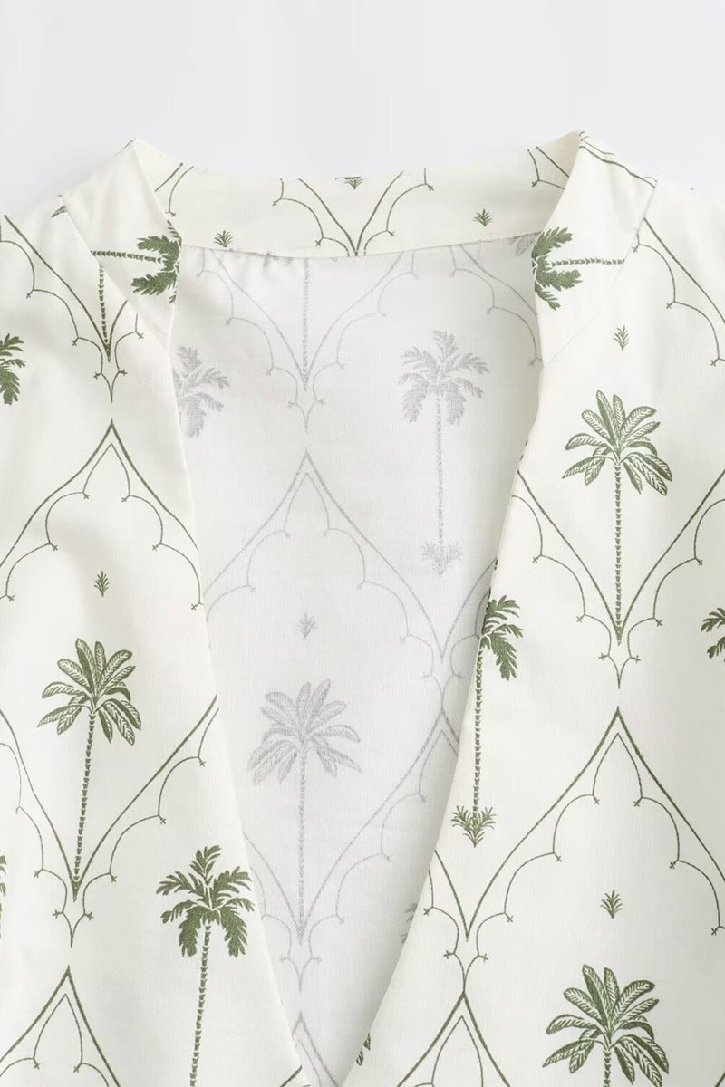White and green Marin Willow wrap mini dress with V-neck by Lumina Vancouver, styled for a chic daytime look.