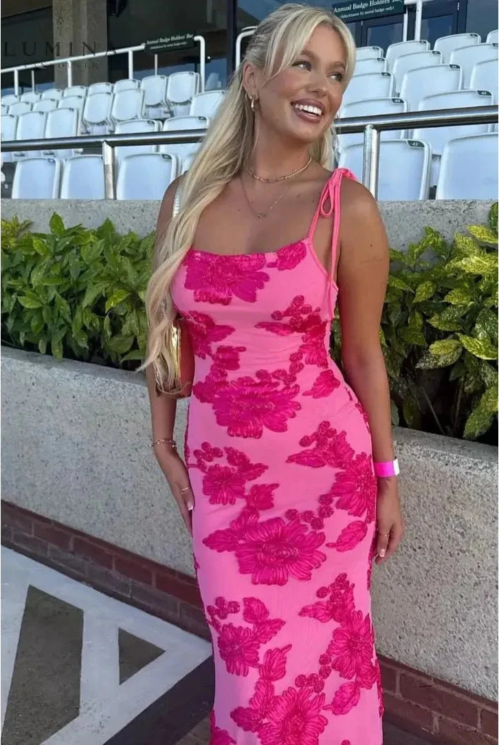 Pink floral knot-strap dress by Lumina Wear, perfect for wedding guests, styled with a flowy silhouette and vibrant floral print.