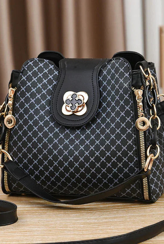 Black Marjorie Lumina Wear quilted charm handbag with adjustable strap, stylish and elegant for versatile everyday use.