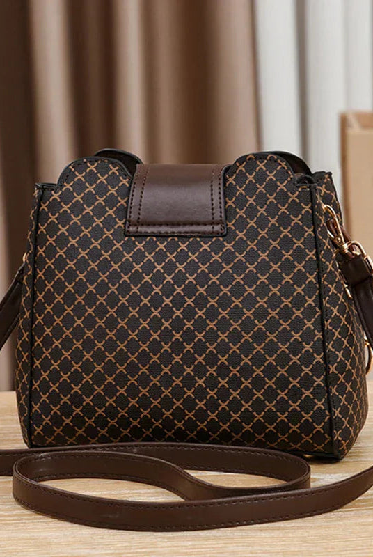 Black Marjorie quilted charm handbag with adjustable strap by Lumina Wear, featuring elegant stitching and compact design.