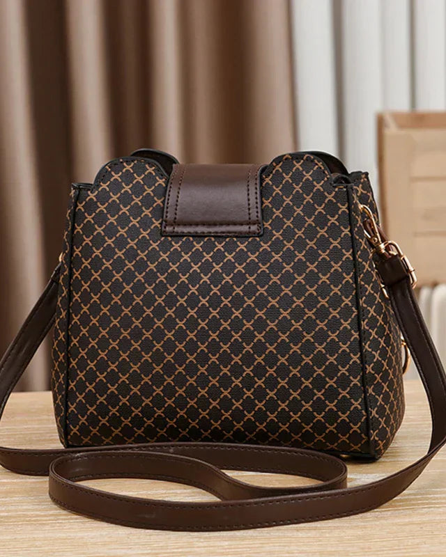 Black Lumina Wear Marjorie quilted handbag with adjustable strap, elegant charm design and compact style for versatile use.