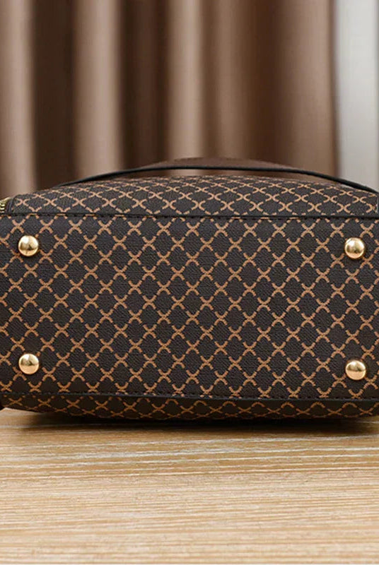 Black Marjorie Lumina Wear quilted charm handbag with adjustable strap, showcasing elegant stitching and compact design.