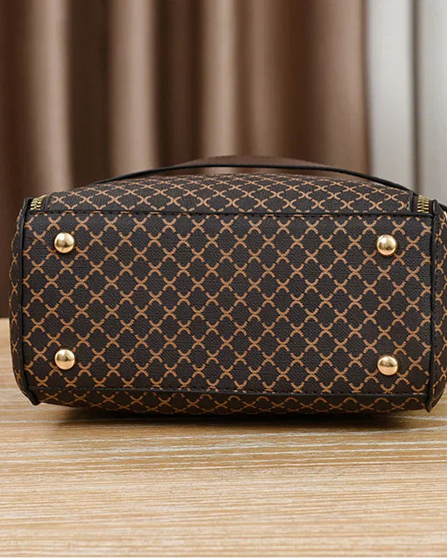 Lumina Wear Marjorie quilted charm handbag with adjustable strap in black, showcasing elegant stitching and stylish design.