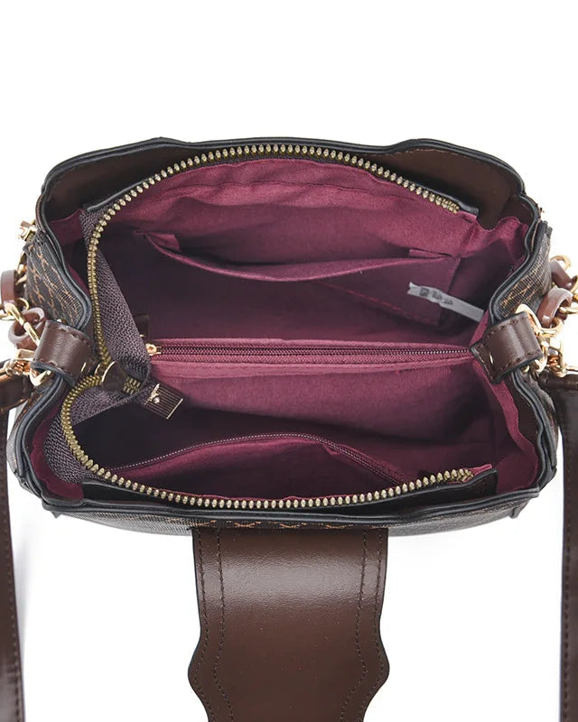 Black Marjorie quilted charm handbag with adjustable strap by Lumina Wear, showcasing elegant stitching and stylish design.