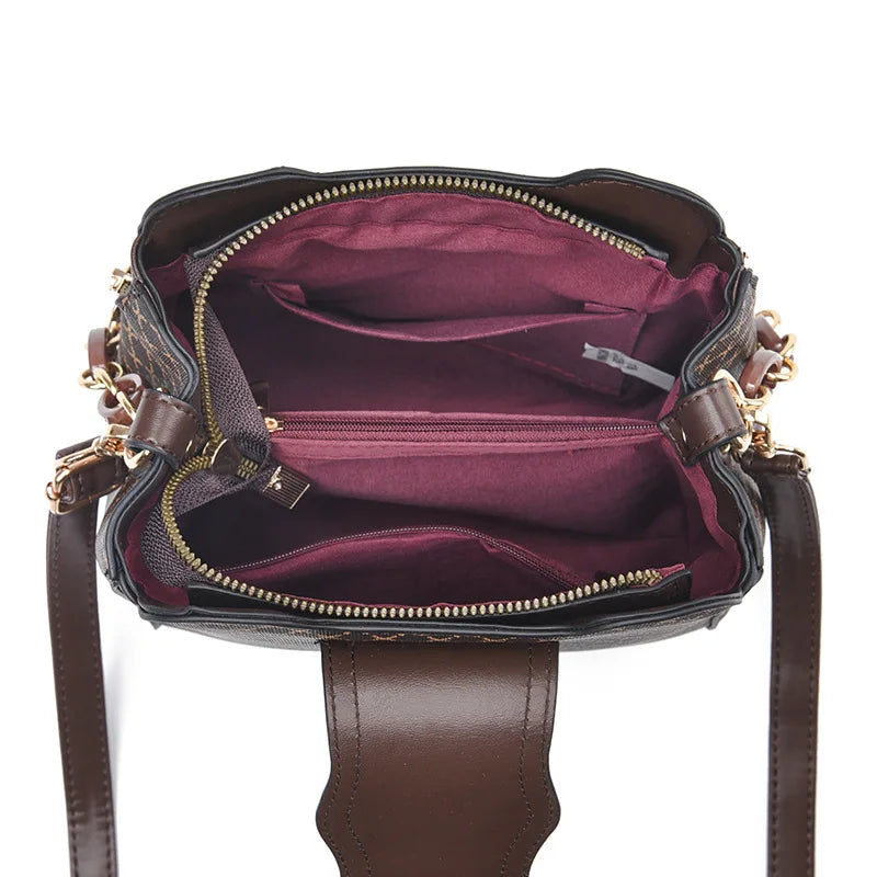 Black Marjorie quilted charm handbag with adjustable strap by Lumina Wear, featuring elegant stitching and compact design.