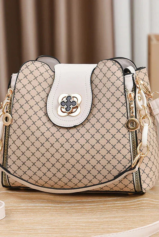 Black Marjorie quilted charm handbag with adjustable strap by Lumina Wear, featuring elegant stitching and compact design.