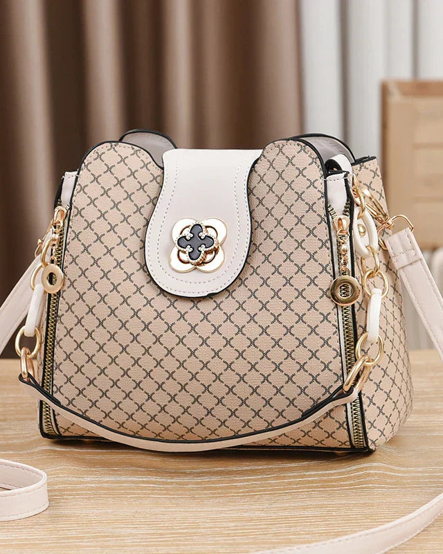 Black Lumina Wear Marjorie quilted charm handbag with adjustable strap, showcasing its elegant design and stylish craftsmanship.