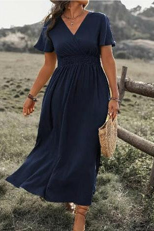 Green MARY™ elegant summer dress with V-neck by Lumina Vancouver, shown on a hanger, stylish and lightweight for warm weather.
