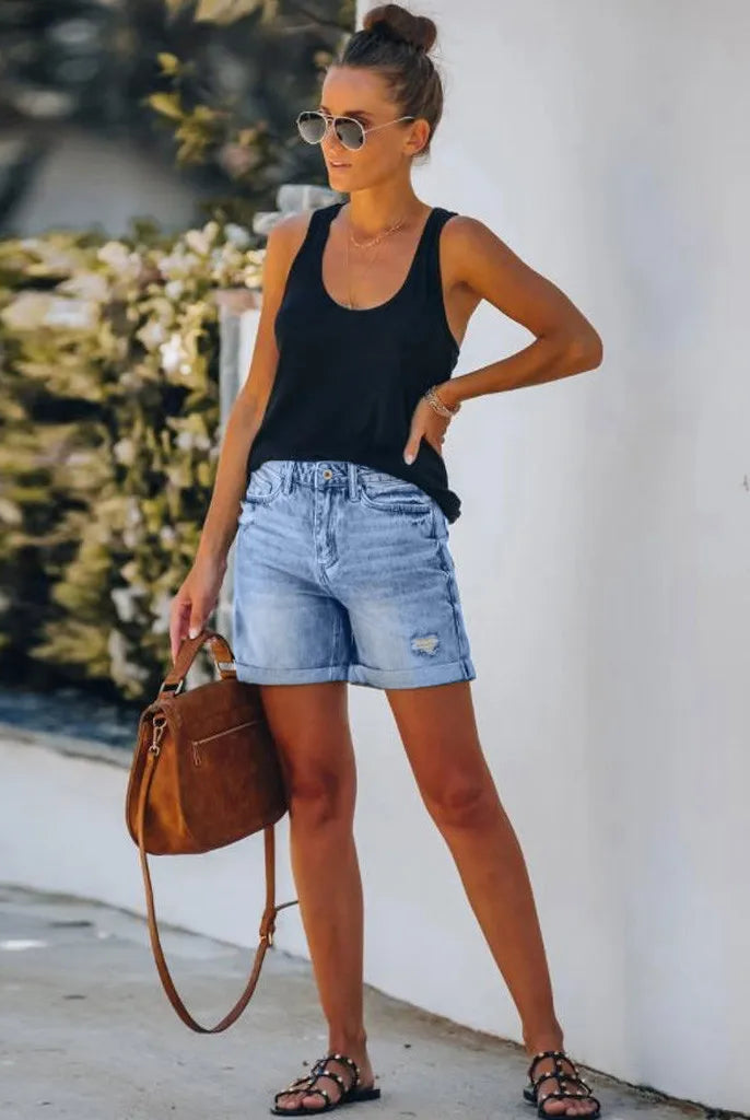 Light blue Mila high-waisted denim shorts with rolled hem from Lumina Wear, showcasing a trendy casual style.