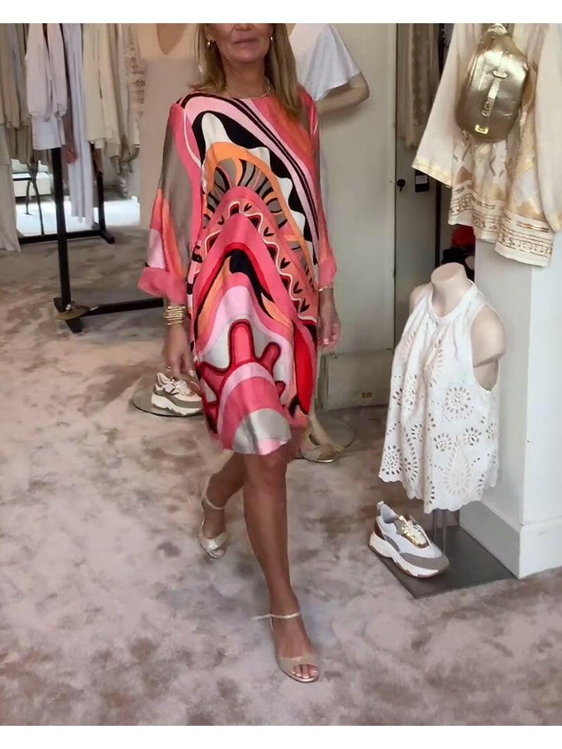 Mirabella™ vibrant coral pink abstract print dress by Lumina Vancouver, shown on a model, stylish and colorful summer dress.