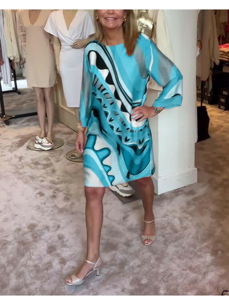 Mirabella™ vibrant abstract print dress in coral pink from Lumina Vancouver, featuring a stylish and colorful design.