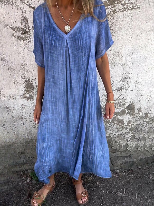 Blue NIA™ maxi dress by Lumina Vancouver, flowy and stylish for summer, displayed on a hanger against a neutral background.